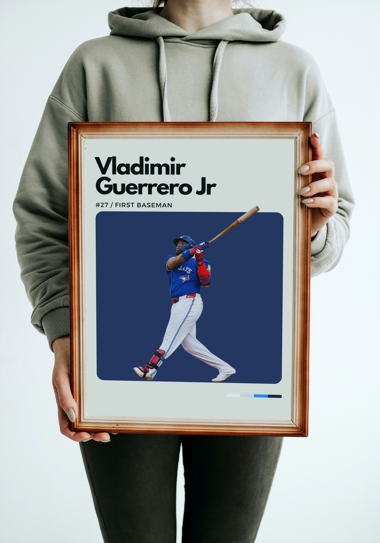 Person holding a framed poster of Vladimir Guerrero Jr. with a baseball player illustration.