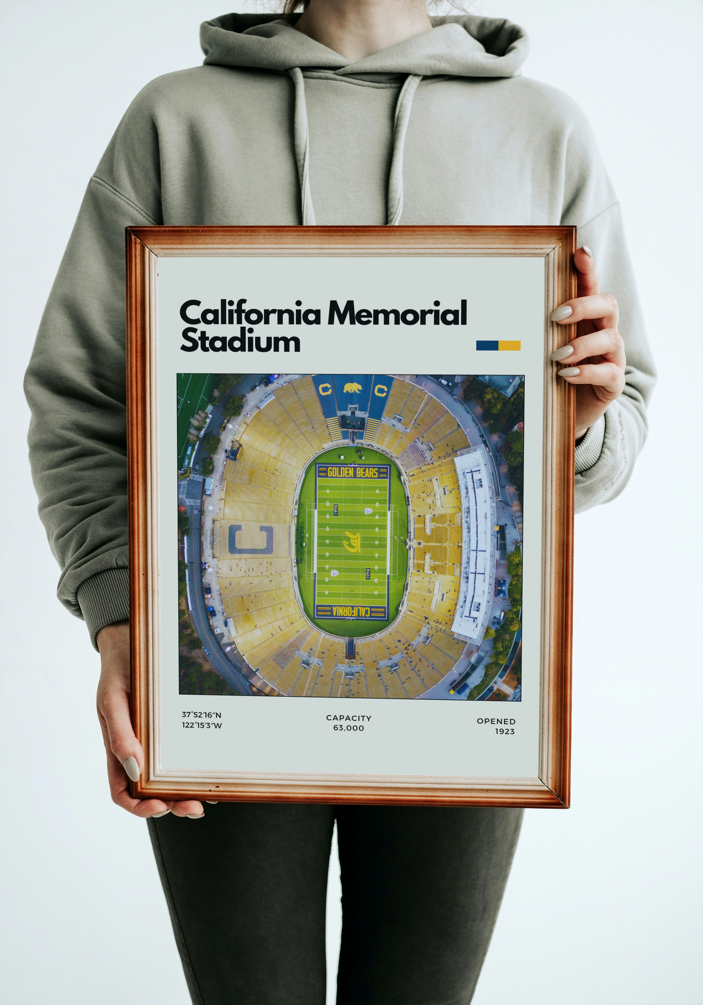 Person holding a framed poster of California Memorial Stadium