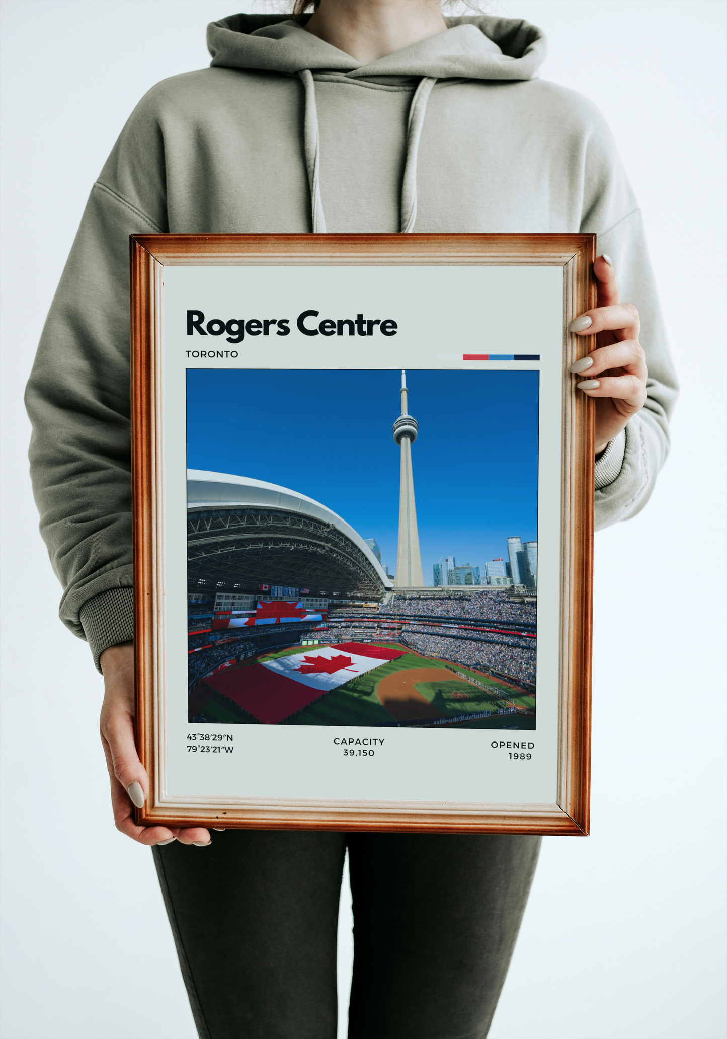 Person holding a framed poster of Rogers Centre in Toronto