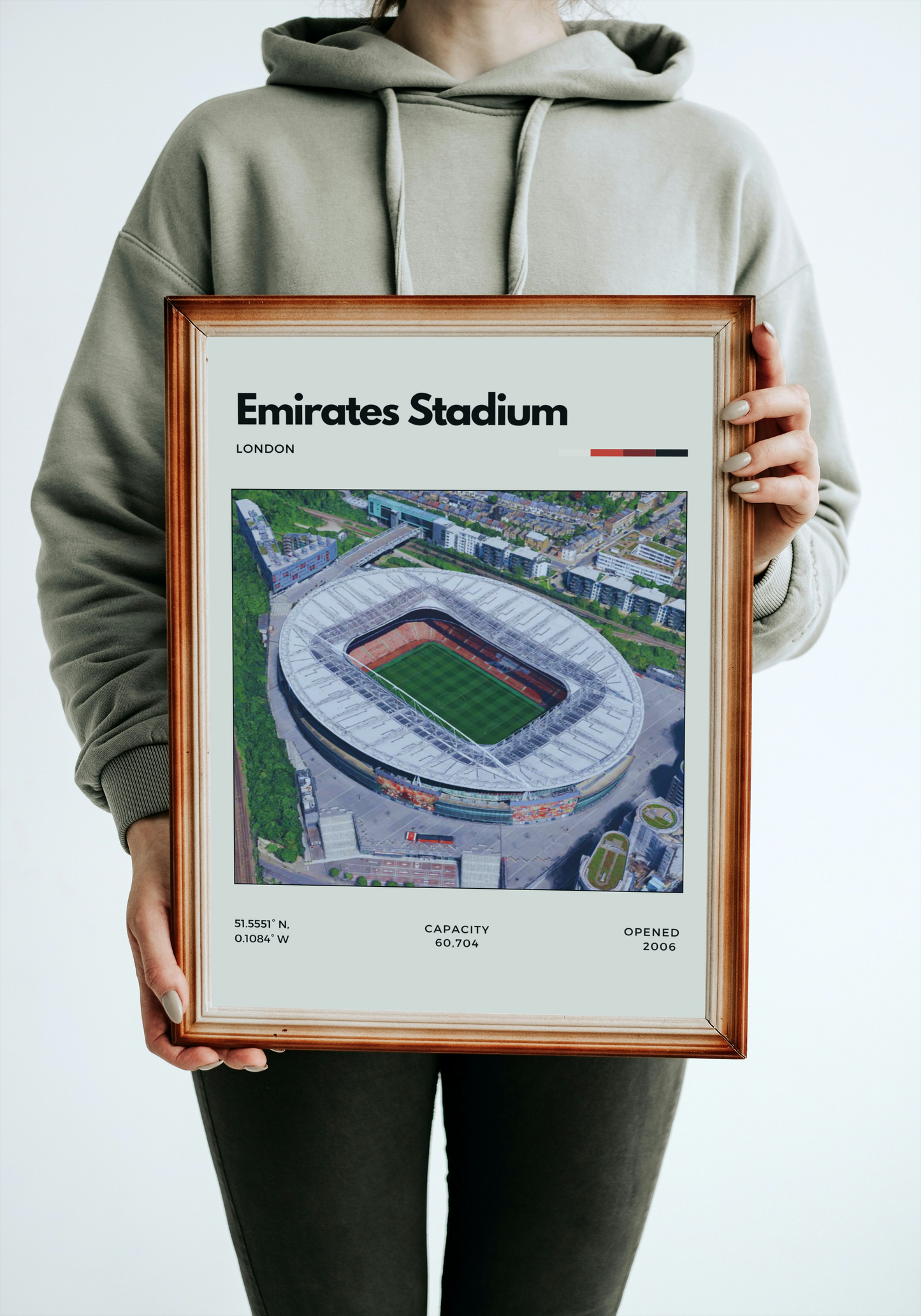 Person holding a framed print of Emirates Stadium
