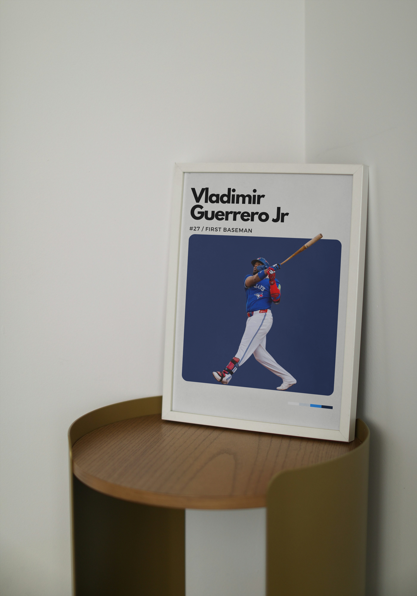 Framed picture of a baseball player on a wooden shelf against a white wall