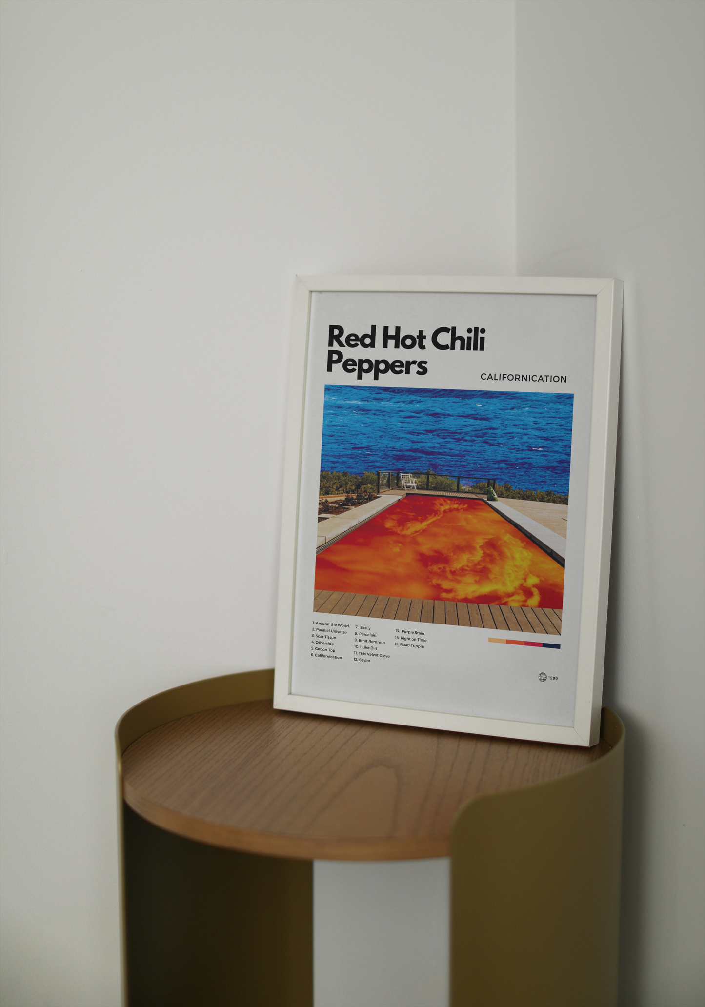 Framed poster of Red Hot Chili Peppers' ' Californication' album cover on a wooden shelf.