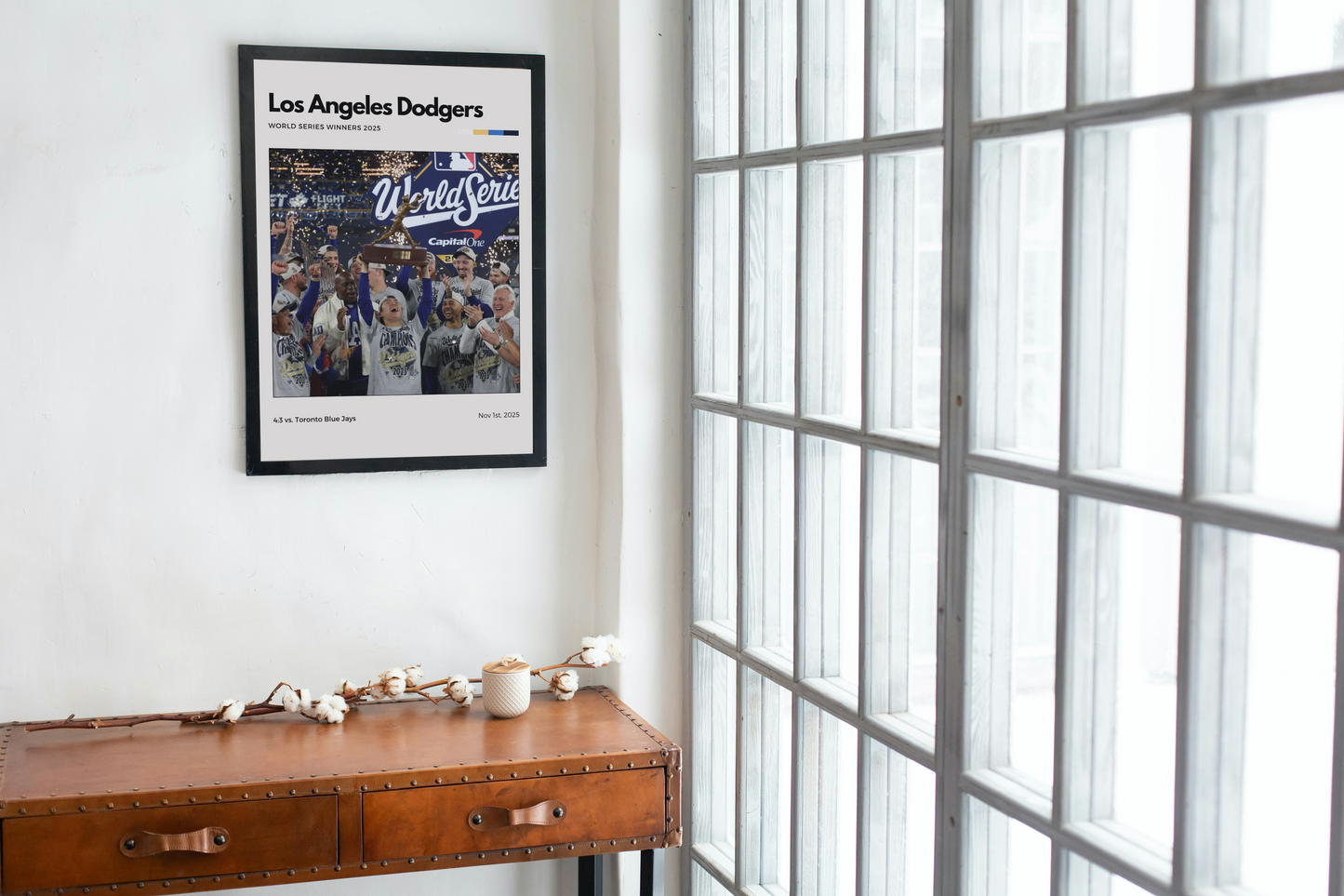 Framed Los Angeles Dodgers World Series poster on a wall next to a window.