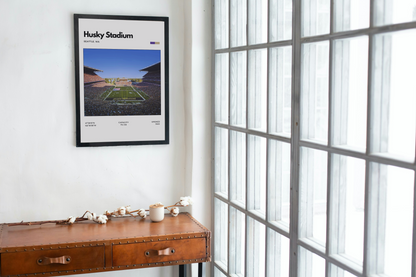 Framed picture of Husky Stadium on a wall next to a window
