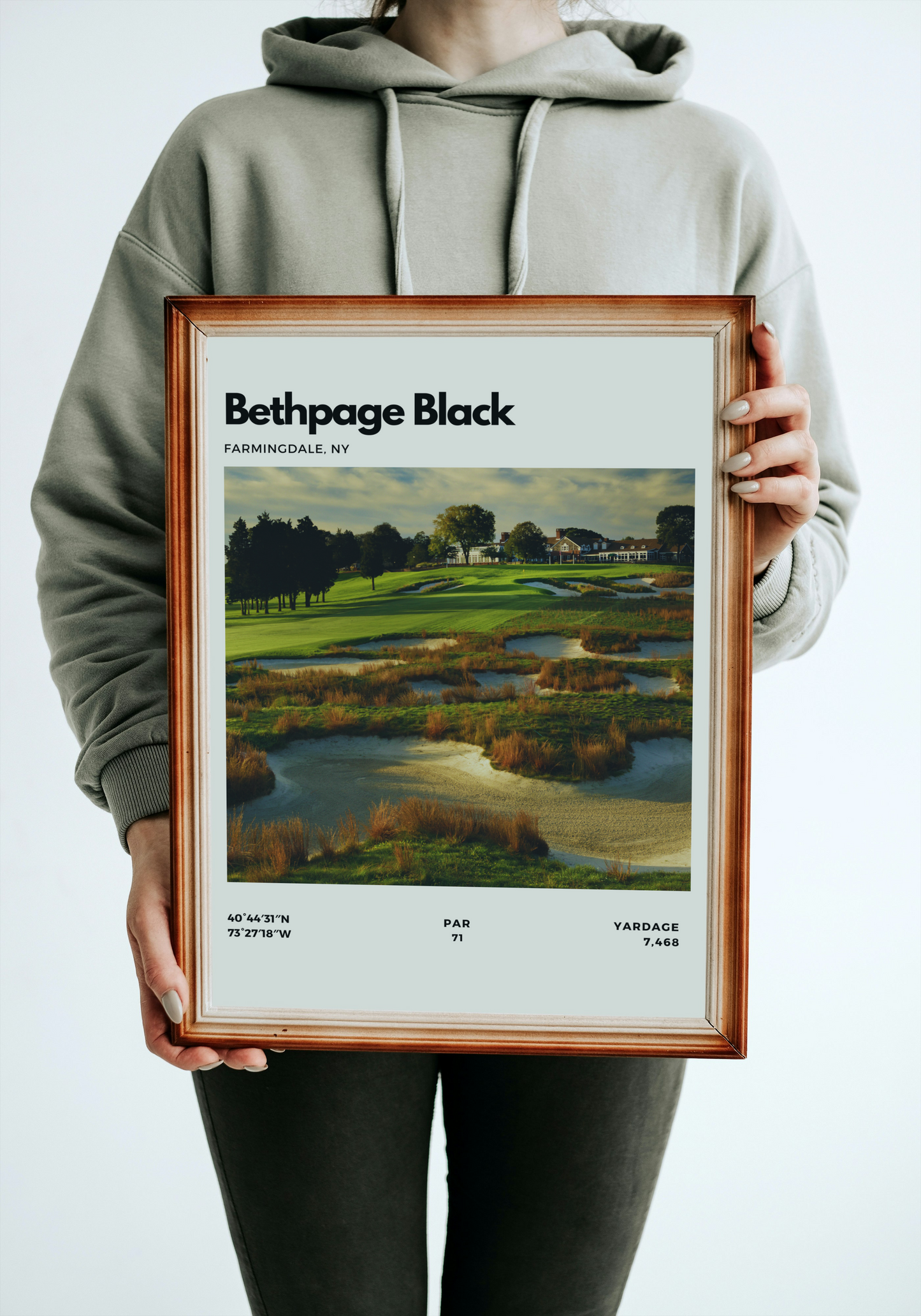 Person holding a framed print of Bethpage Black golf course