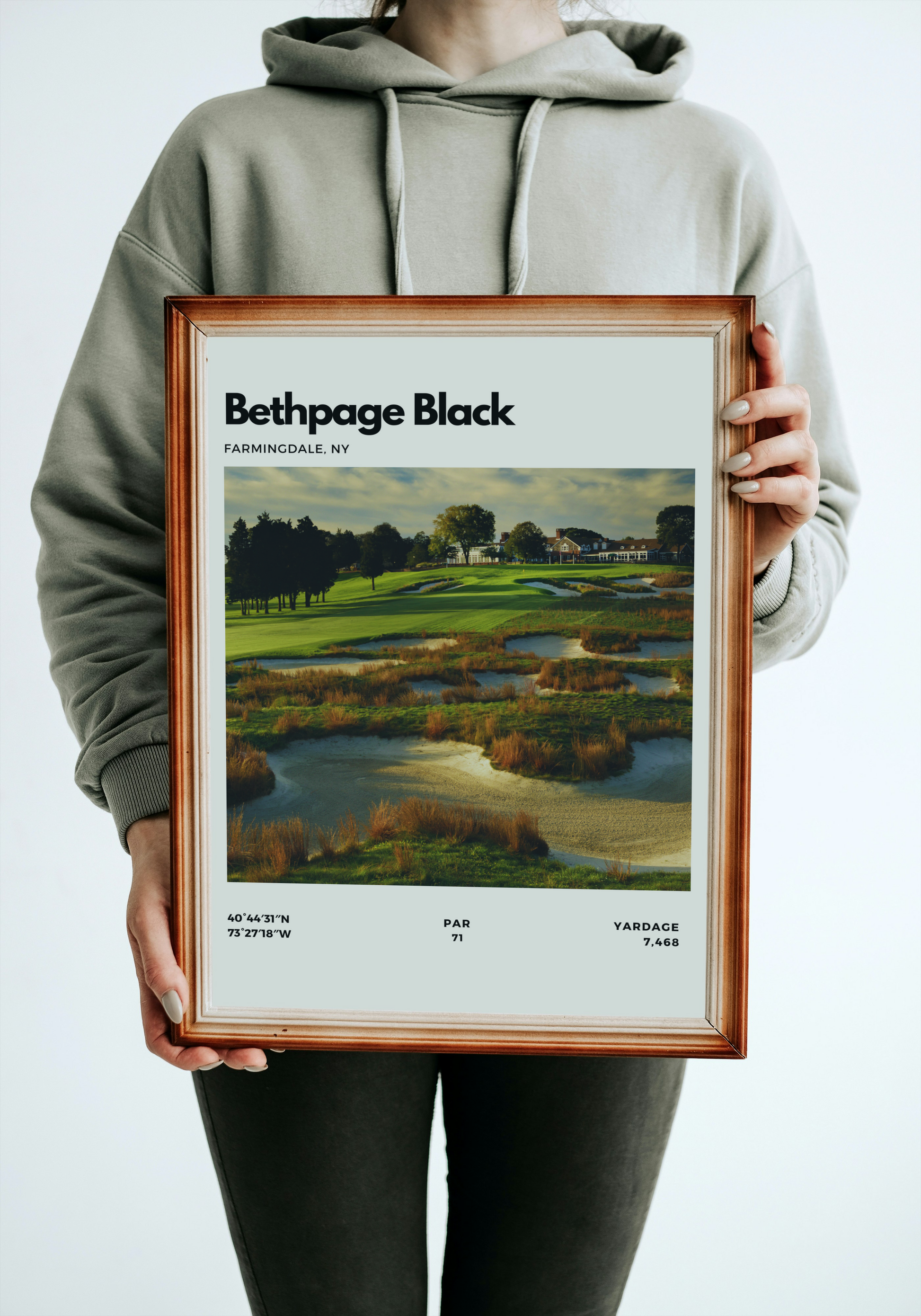Person holding a framed print of Bethpage Black golf course