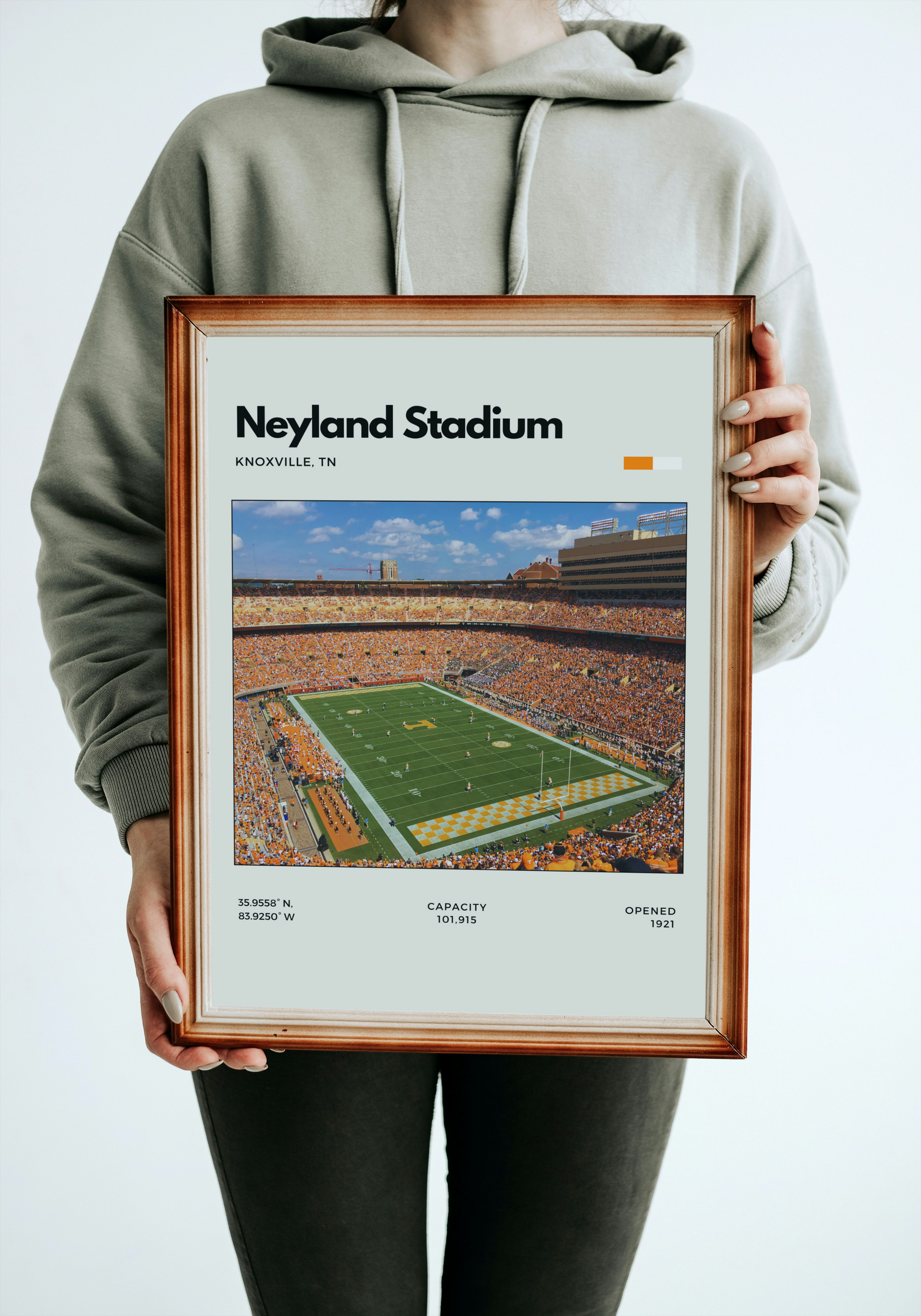 Person holding a framed poster of Neyland Stadium