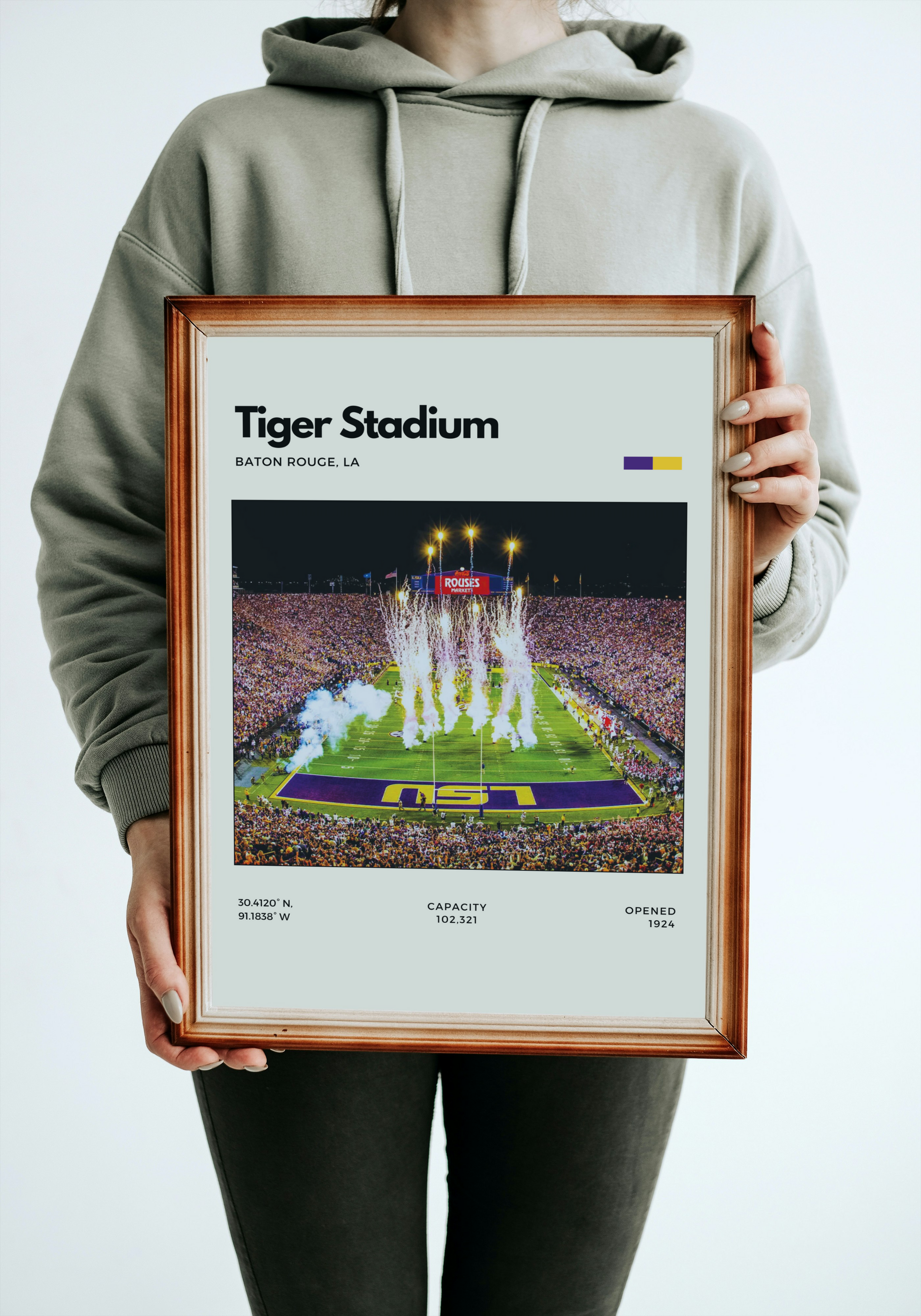 Person holding a framed print of Tiger Stadium with LSU Tigers on a football field.