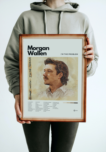 Person holding a framed poster of Morgan Wallen with album cover and text.