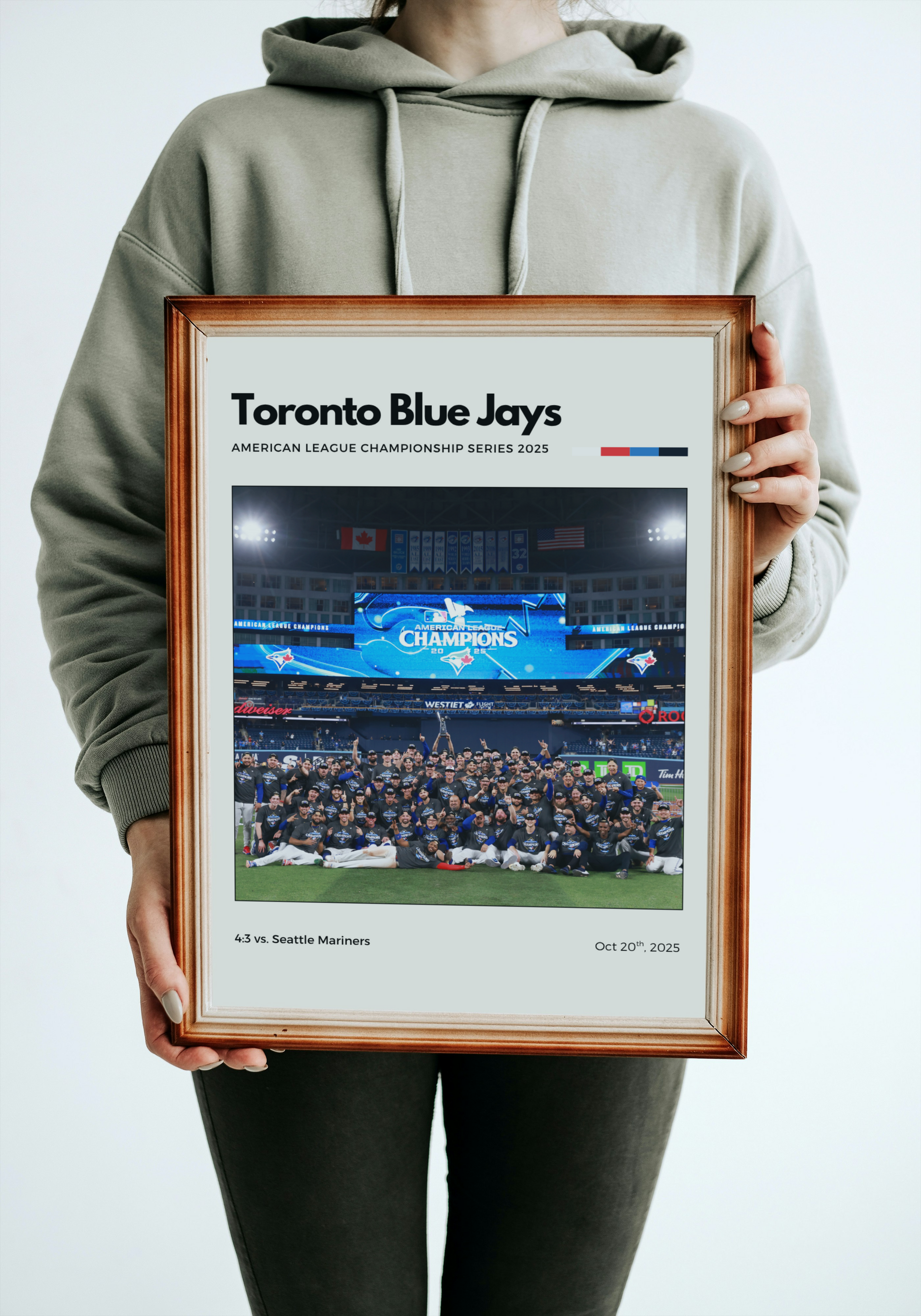 Person holding a framed picture of the Toronto Blue Jays with championship details.