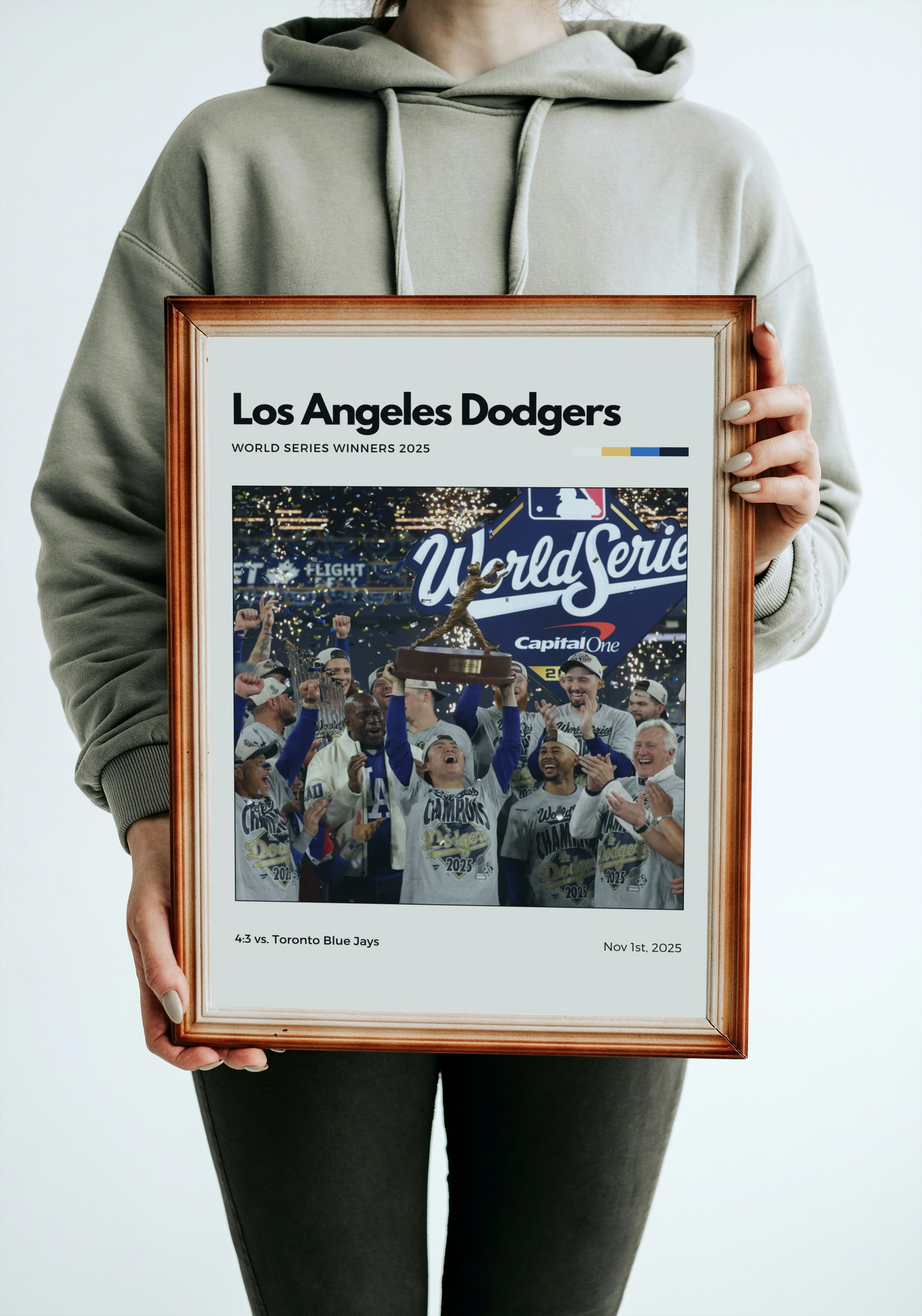 Person holding a framed Los Angeles Dodgers World Series poster