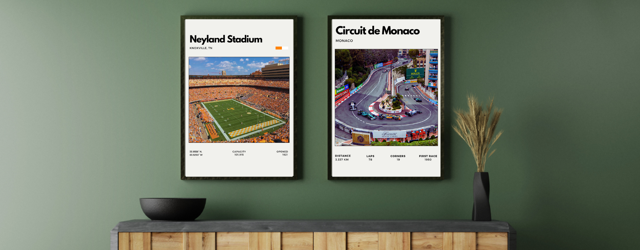 Two framed posters of Neyland Stadium and Circuit de Monaco on a green wall.