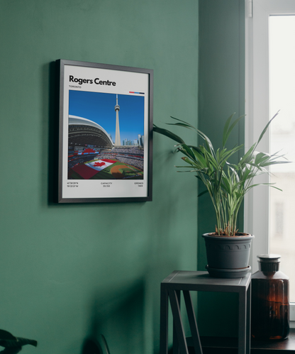Framed poster of Rogers Centre on a green wall with a plant and bottle in the foreground.