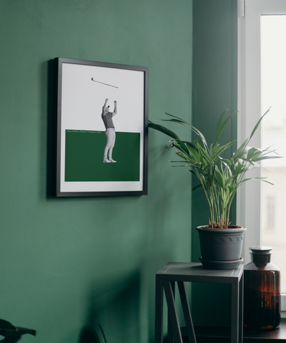Framed artwork of Rory McIlroy on a green wall with a plant and bottle in the foreground.